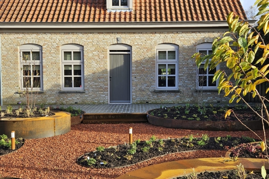 The design of this front yard in Oud Gastel is characterized by organic shapes.